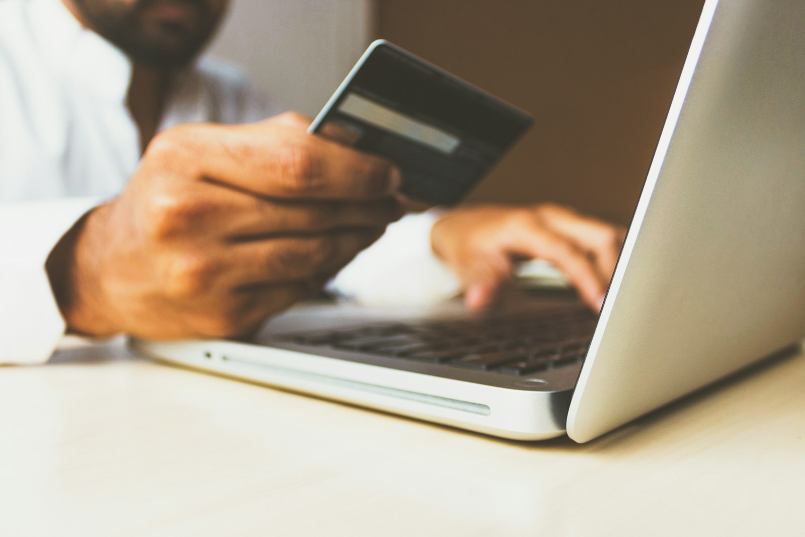Customer entering card details on a laptop to pay for an online order